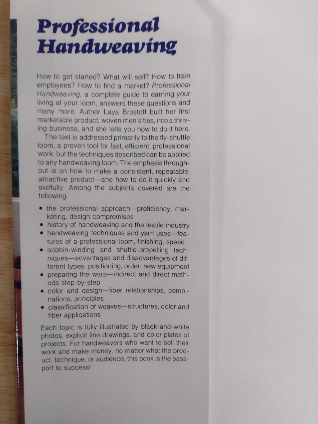 A printed booklet or book page titled 'Professional Handweaving' with a large blue title and black explanatory text, photographed at an angle on a white background.